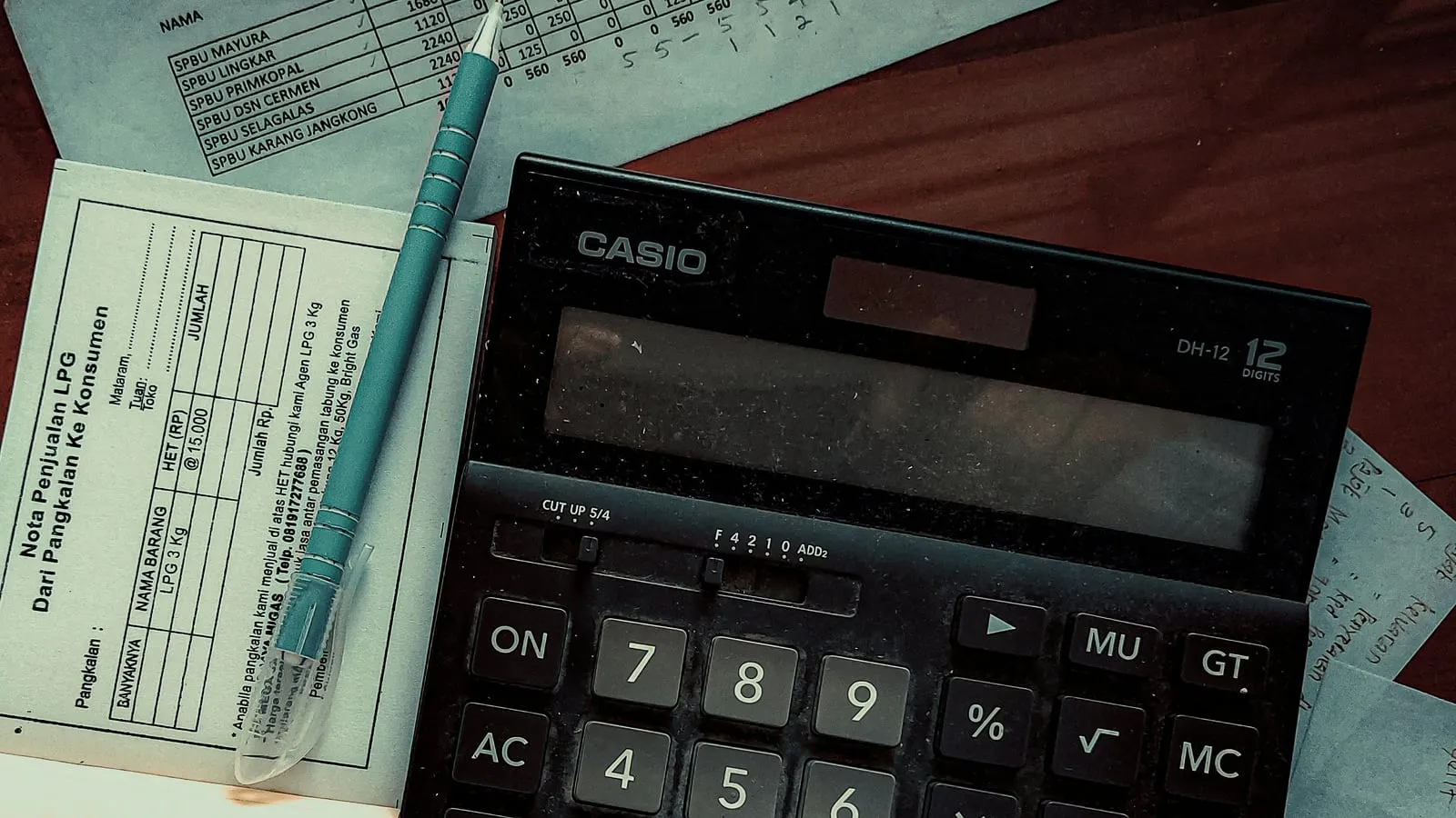 Calculator and paper records on a desk